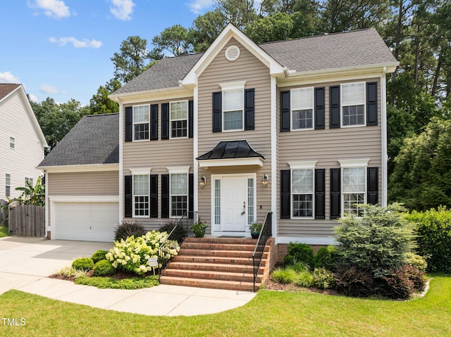 1802 Abby Knoll Dr, Apex, NC 27502 - colonial house featuring concrete driveway, an attached garage, and a shingled roof