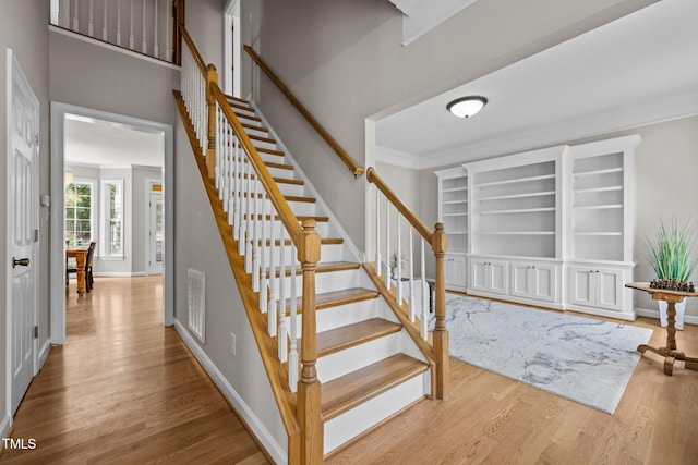 1802 Abby Knoll Dr, Apex, NC 27502 - staircase with wood finished floors and crown molding