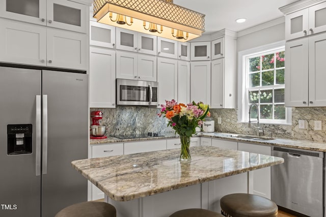 1802 Abby Knoll Dr, Apex, NC 27502 - kitchen with stainless steel appliances, a kitchen breakfast bar, decorative backsplash, white cabinetry, and recessed lighting