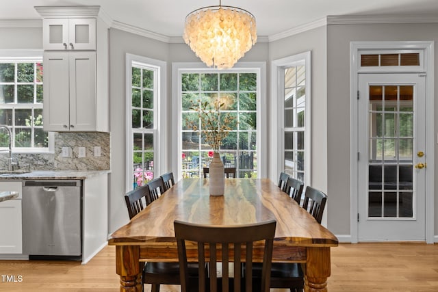 1802 Abby Knoll Dr, Apex, NC 27502 - dining space with a chandelier, light wood-style floors, plenty of natural light, and crown molding