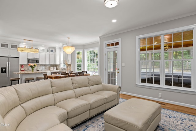 1802 Abby Knoll Dr, Apex, NC 27502 - living area featuring a chandelier, light wood-style flooring, recessed lighting, and crown molding