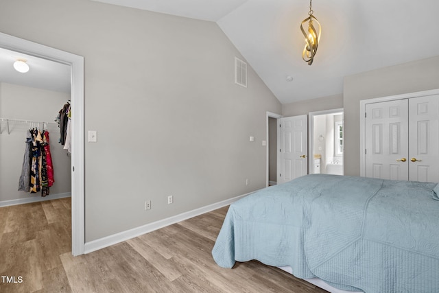 1802 Abby Knoll Dr, Apex, NC 27502 - bedroom featuring lofted ceiling, wood finished floors, and a spacious closet