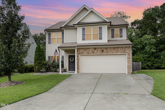 118 Truss Way, Durham, NC 27704 - view of front facade with stone siding, driveway, a garage, and a front yard