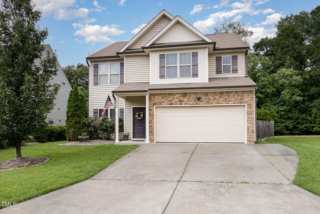 118 Truss Way, Durham, NC 27704 - view of front of property with stone siding, driveway, a garage, and a front yard