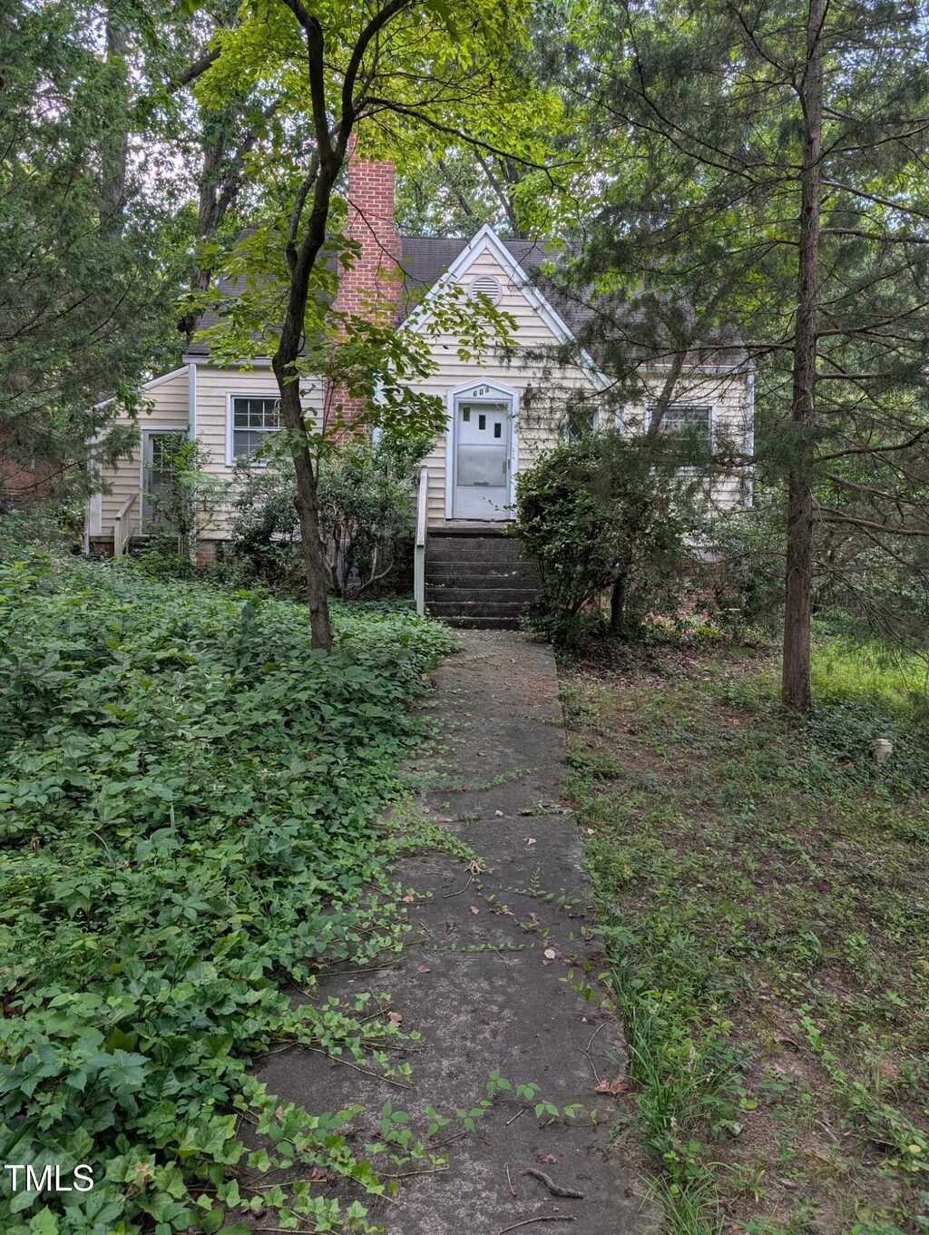 603 Stacy St, Raleigh, NC 27607 - obstructed view of property featuring a chimney