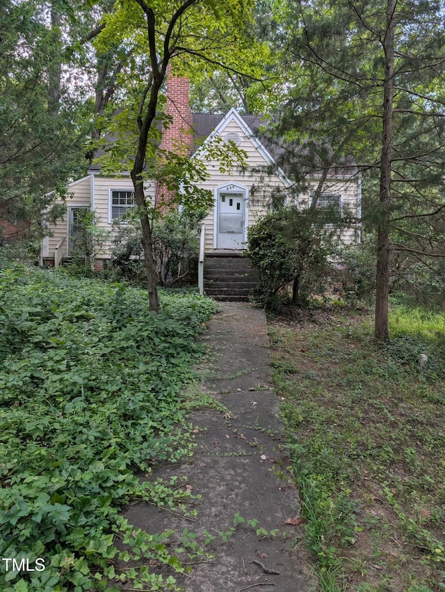 603 Stacy St, Raleigh, NC 27607 - obstructed view of property featuring a chimney