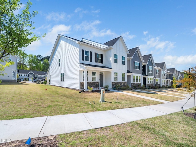 1650 Singing Bird Trl, Wake Forest, NC 27587 - view of front of house featuring a residential view, board and batten siding, stone siding, and a front yard
