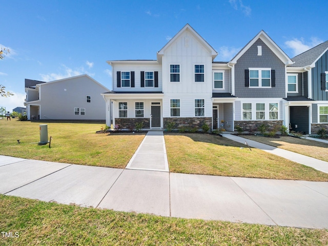 1650 Singing Bird Trl, Wake Forest, NC 27587 - view of property featuring board and batten siding, a front lawn, and stone siding
