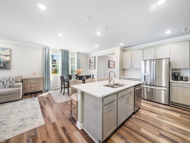 1650 Singing Bird Trl, Wake Forest, NC 27587 - kitchen with stainless steel appliances, crown molding, gray cabinets, tasteful backsplash, and light countertops