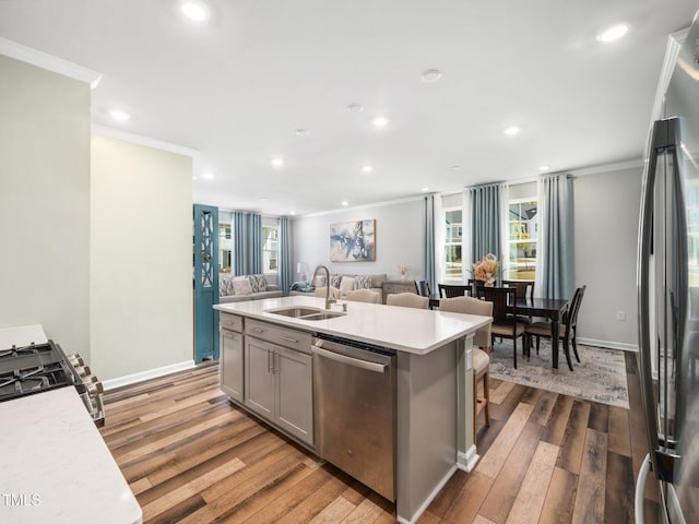 1650 Singing Bird Trl, Wake Forest, NC 27587 - kitchen with stainless steel appliances, crown molding, dark wood-style floors, light countertops, and recessed lighting