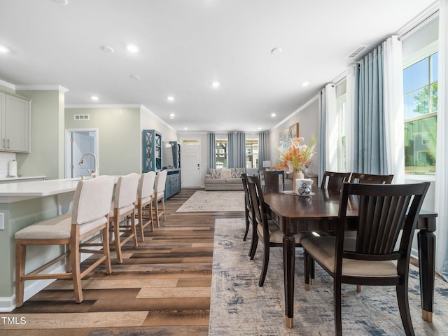 1650 Singing Bird Trl, Wake Forest, NC 27587 - dining room featuring ornamental molding, dark wood-style flooring, plenty of natural light, and recessed lighting