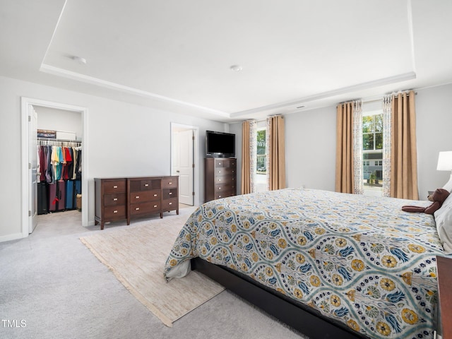 1650 Singing Bird Trl, Wake Forest, NC 27587 - bedroom featuring a raised ceiling, light carpet, a spacious closet, and a closet