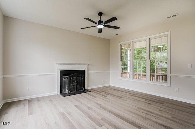 413 Hanska Way, Raleigh, NC 27610 - unfurnished living room with wood finished floors, a ceiling fan, and a fireplace