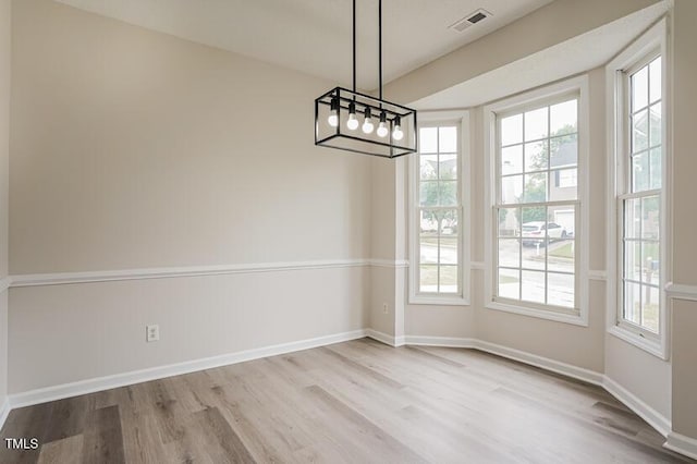 413 Hanska Way, Raleigh, NC 27610 - unfurnished dining area featuring wood finished floors and plenty of natural light