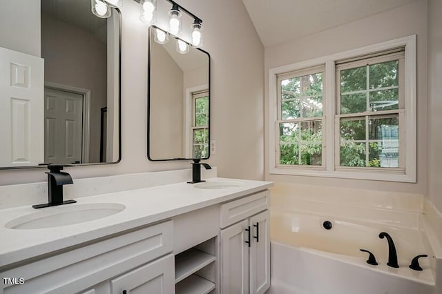 413 Hanska Way, Raleigh, NC 27610 - full bath with double vanity, a bath, and vaulted ceiling