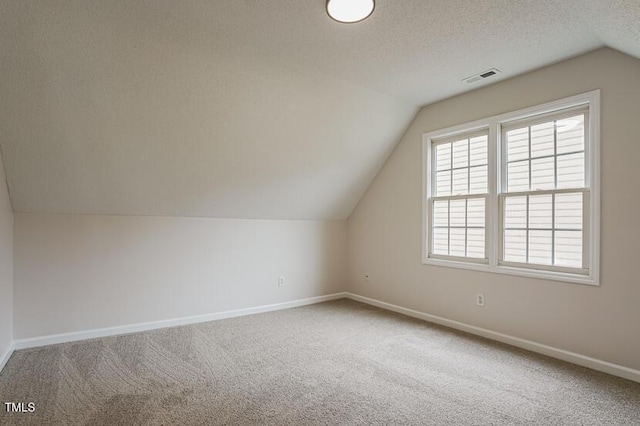 413 Hanska Way, Raleigh, NC 27610 - bonus room featuring lofted ceiling, carpet, and a textured ceiling
