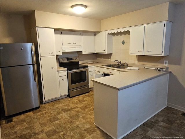 1918 Roxie Ave, Fayetteville, NC 28304 - kitchen with appliances with stainless steel finishes, under cabinet range hood, a peninsula, and white cabinets