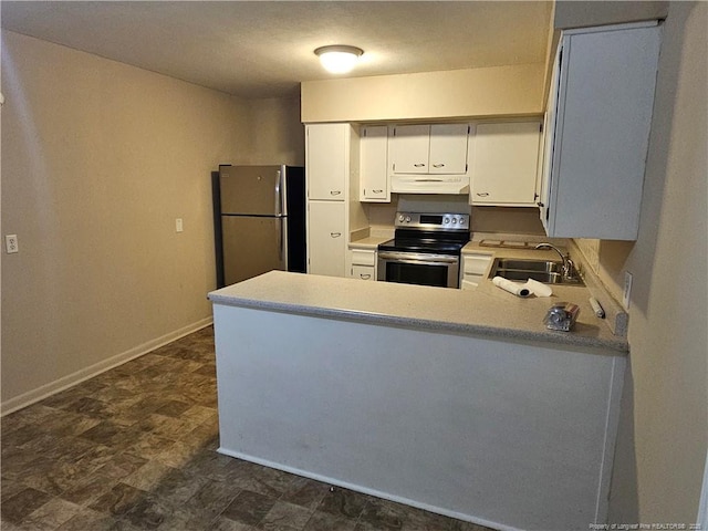 1918 Roxie Ave, Fayetteville, NC 28304 - kitchen featuring stainless steel electric range, freestanding refrigerator, under cabinet range hood, a peninsula, and light countertops
