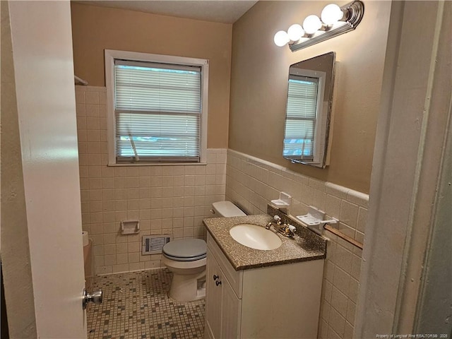 1918 Roxie Ave, Fayetteville, NC 28304 - bathroom with tile walls, vanity, tile patterned floors, and a wainscoted wall