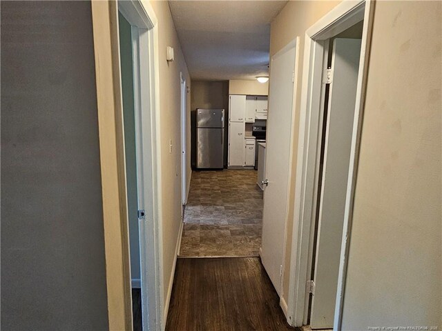 1918 Roxie Ave, Fayetteville, NC 28304 - corridor with baseboards and dark wood-type flooring