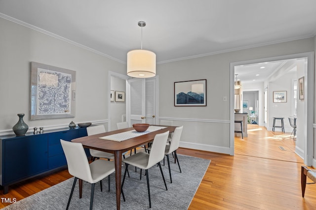 2706 Stuart Dr, Durham, NC 27707 - dining room with light wood-style floors and crown molding