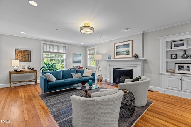 2706 Stuart Dr, Durham, NC 27707 - living room featuring light wood finished floors, a fireplace with flush hearth, ornamental molding, and recessed lighting