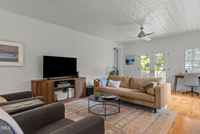 2706 Stuart Dr, Durham, NC 27707 - living area featuring an ornate ceiling, french doors, light wood-style flooring, brick wall, and a ceiling fan