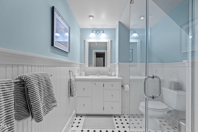 2706 Stuart Dr, Durham, NC 27707 - full bathroom featuring a wainscoted wall, vanity, a stall shower, and tile patterned floors