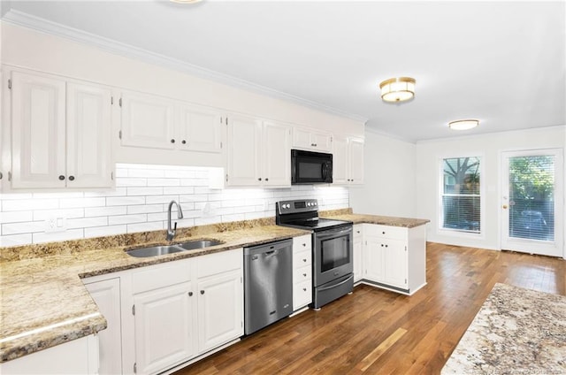106 Woodrow St, Fayetteville, NC 28303 - kitchen with stainless steel appliances, ornamental molding, dark wood-style floors, white cabinetry, and decorative backsplash