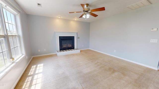 14 Gloucester Ct, Cameron, NC 28326 - unfurnished living room with light carpet, a ceiling fan, and a glass covered fireplace