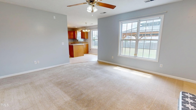 14 Gloucester Ct, Cameron, NC 28326 - unfurnished living room featuring a chandelier, light colored carpet, and a ceiling fan