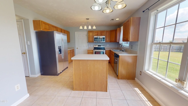 14 Gloucester Ct, Cameron, NC 28326 - kitchen with appliances with stainless steel finishes, a chandelier, light countertops, a center island, and light tile patterned flooring