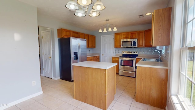 14 Gloucester Ct, Cameron, NC 28326 - kitchen with stainless steel appliances, a chandelier, light countertops, and a center island