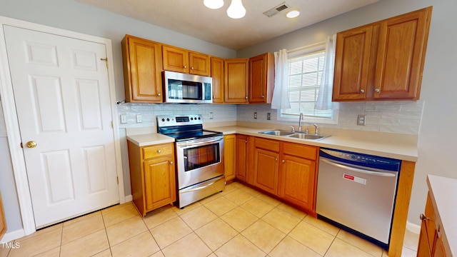 14 Gloucester Ct, Cameron, NC 28326 - kitchen with stainless steel appliances, light countertops, backsplash, and brown cabinets