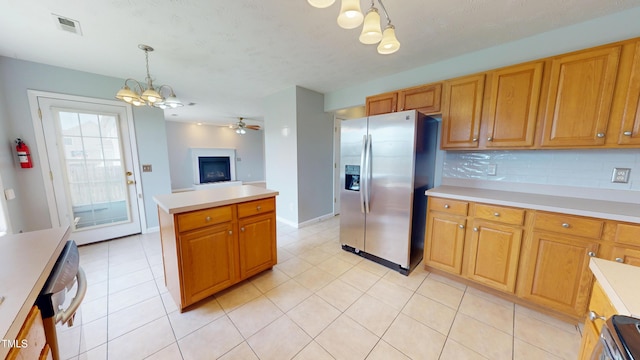 14 Gloucester Ct, Cameron, NC 28326 - kitchen featuring stainless steel fridge with ice dispenser, a chandelier, light countertops, and hanging light fixtures