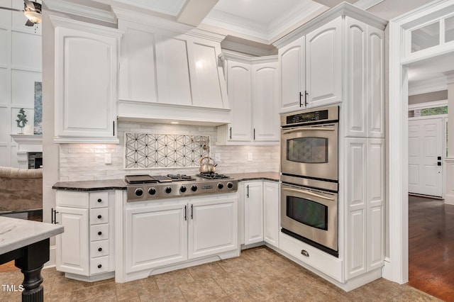 12452 Richmond Run Dr, Raleigh, NC 27614 - kitchen featuring appliances with stainless steel finishes, dark stone counters, white cabinets, tasteful backsplash, and crown molding