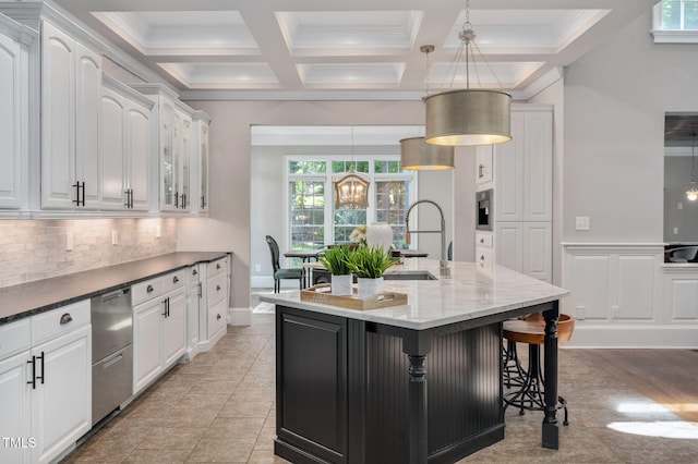 12452 Richmond Run Dr, Raleigh, NC 27614 - kitchen with white cabinetry, healthy amount of natural light, tasteful backsplash, a center island with sink, and coffered ceiling