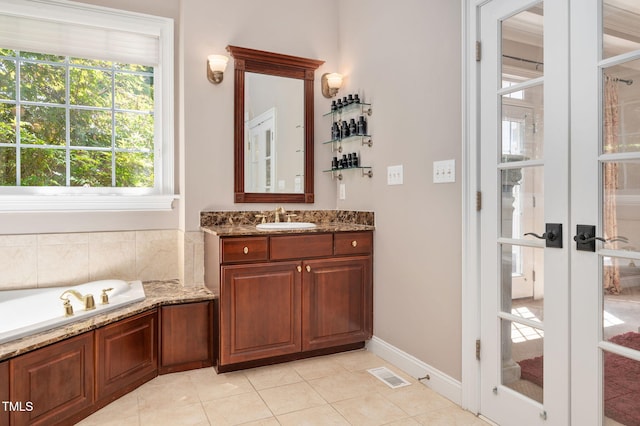 12452 Richmond Run Dr, Raleigh, NC 27614 - bathroom featuring vanity, a garden tub, french doors, and tile patterned floors