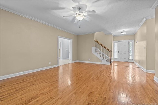85 Shining Water Ln, Spring Lake, NC 28390 - entryway with stairs, light wood finished floors, a ceiling fan, and crown molding