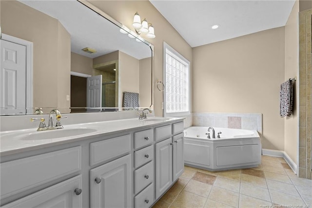 85 Shining Water Ln, Spring Lake, NC 28390 - bathroom with double vanity, tiled shower, a garden tub, and tile patterned floors