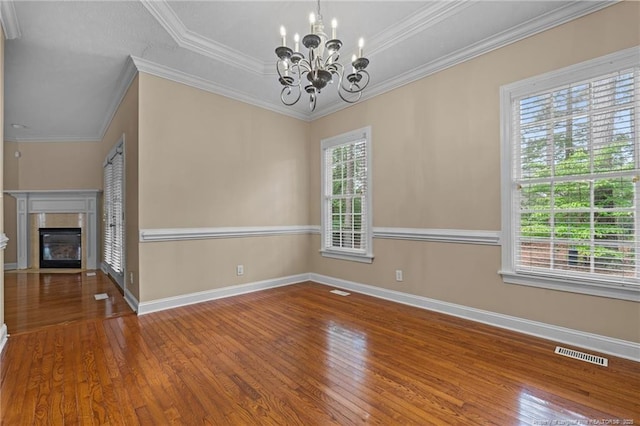 85 Shining Water Ln, Spring Lake, NC 28390 - unfurnished dining area featuring healthy amount of natural light, wood finished floors, a chandelier, and ornamental molding