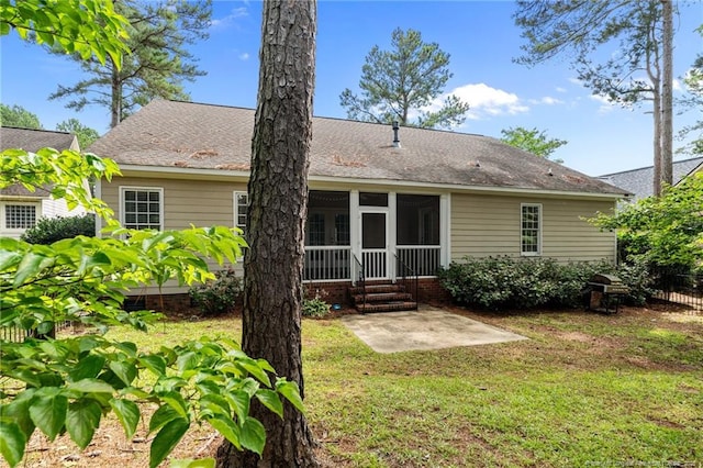 85 Shining Water Ln, Spring Lake, NC 28390 - rear view of property featuring a lawn, a sunroom, and a patio area