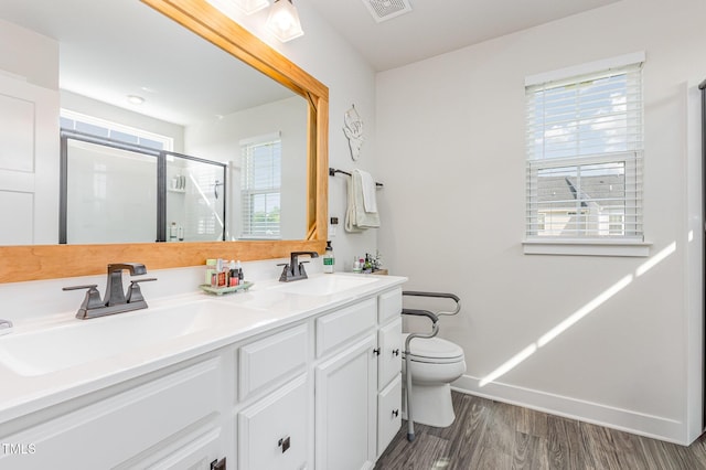 235 Misty Pike Dr, Raleigh, NC 27603 - bathroom featuring wood finished floors, a stall shower, and double vanity