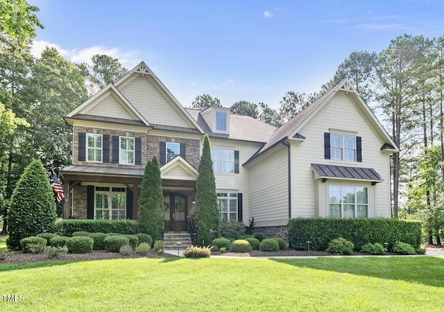 7112 Hasentree Way, Wake Forest, NC 27587 - craftsman house featuring a standing seam roof, a front yard, and stone siding