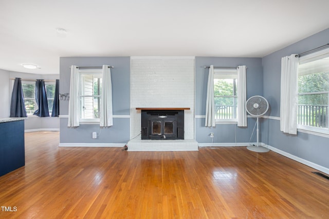 3542 Anderson Valley Rd, Mcleansville, NC 27301 - unfurnished living room with plenty of natural light, wood finished floors, and a fireplace