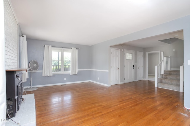 3542 Anderson Valley Rd, Mcleansville, NC 27301 - unfurnished living room featuring stairs, wood finished floors, and a fireplace