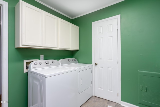 3542 Anderson Valley Rd, Mcleansville, NC 27301 - laundry area featuring cabinet space, washer and clothes dryer, light wood-style floors, and ornamental molding