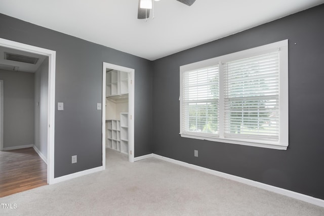 3542 Anderson Valley Rd, Mcleansville, NC 27301 - unfurnished bedroom featuring carpet flooring, a walk in closet, a ceiling fan, and a closet