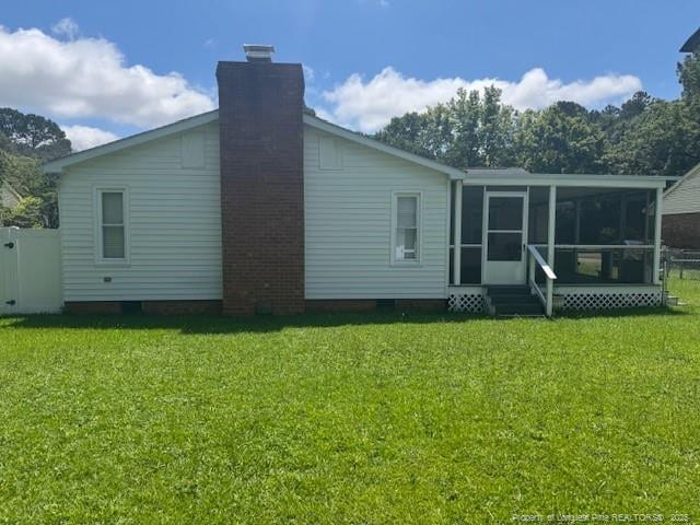 5027 Chesapeake Rd, Fayetteville, NC 28311 - back of property featuring a sunroom and a chimney