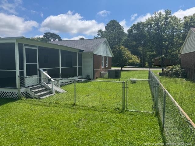 5027 Chesapeake Rd, Fayetteville, NC 28311 - back of property featuring a sunroom and a gate